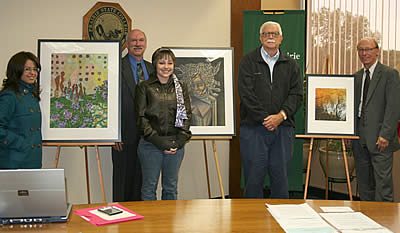 left to right are Blanca Martinez, of Chicago Heights, with her mixed-media collage, Vida Con Carino; PSC Board Chair Mark Fazzini; Ryan Niksic, of Crete, with her pastel drawing, Medusa; David Wedryk, of South Holland, with his photograph, Reflections; and PSC President Dr. Eric C. Radtke.