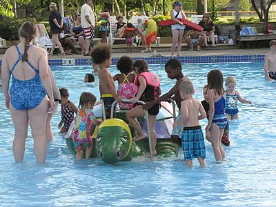 Children play in the wading pool at the Aqua Center