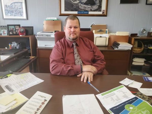 Village Manager Tom Mick at his desk, the Village is hiring