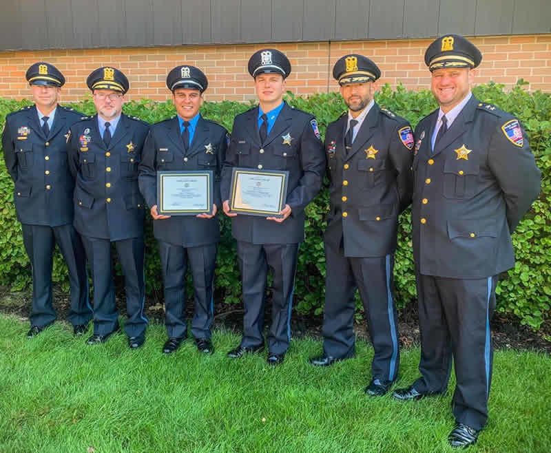 Police Officers Luis Ibarra (left, with certificate) and Kristopher Dlugopolski (right, with certificate) graduated from the Cook County Sheriff’s Police Training Academy