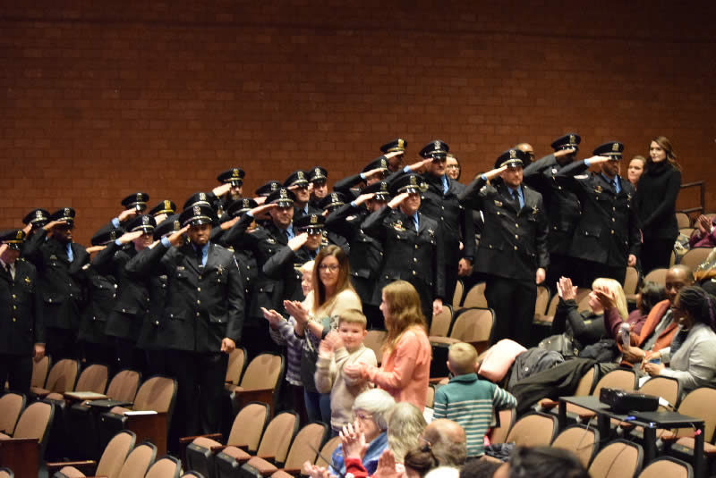 Officers salute family members and the public Saturday.