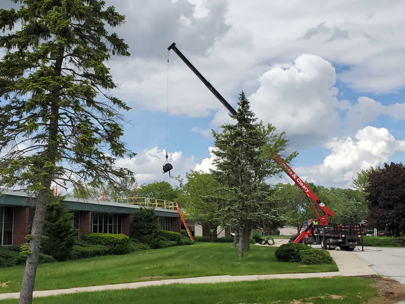 Roofers work at Marian Catholic in May 2020