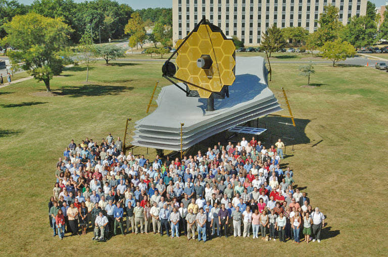 Scientists with a model of the James Webb Space Telescope in 2005.