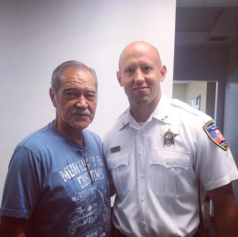 retired police chief standing next to officer