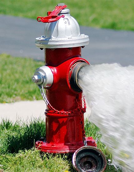 red fire hydrant spyaying water