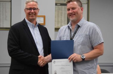 John Harrington presents Mark Pries with a GFOA Certificate of Excellence in Financial Reporting.