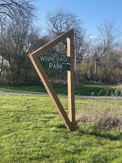 wooden sign displaying park name