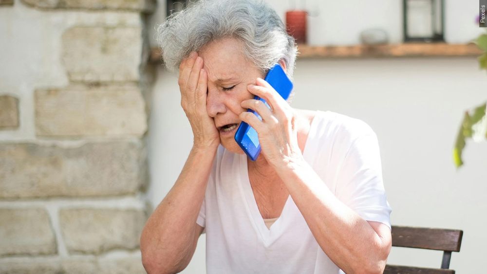 older woman on phone crying