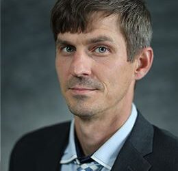 picture of a man wearing a suitcoat, blue shirt and tie