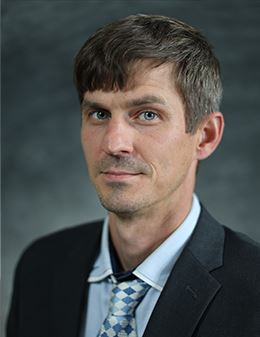picture of a man wearing a suitcoat, blue shirt and tie