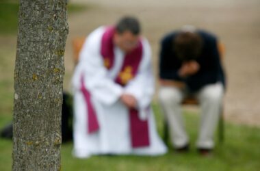 A priest hearing confessions outdoors