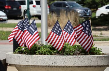 American flags in a planter, wheels of honor
