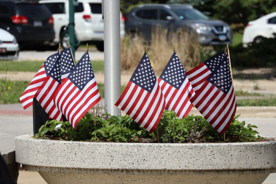 American flags in a planter, wheels of honor