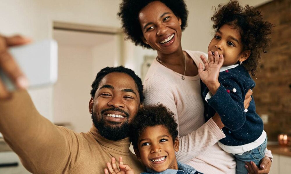 happy Black parents with kids, financial assistance program