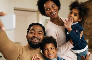 happy Black parents with kids, financial assistance program