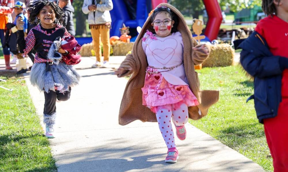 Two girls running on Pumpkin Day 2025