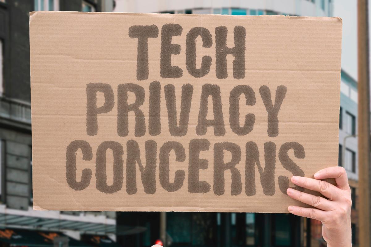 tech privacy concerns on cardboard sign