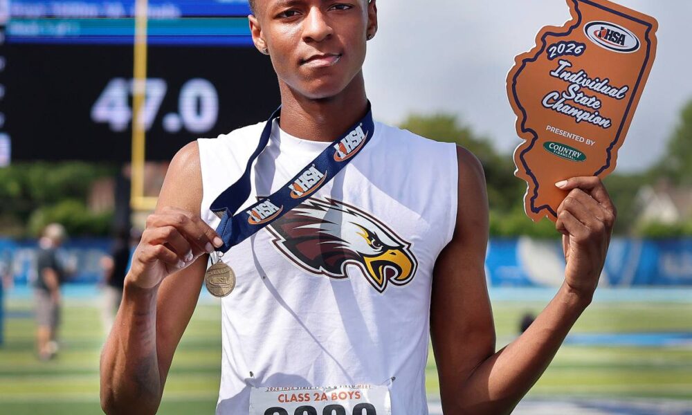Amauree Williams holding medal and award.