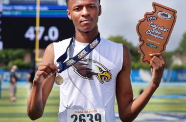 Amauree Williams holding medal and award.